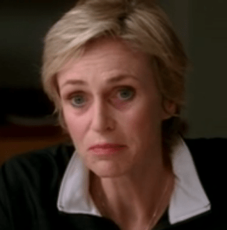 Glee Jane Lynch as Sue Sylvester pretending to bite Chris Colfer