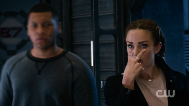 Sara Lance pointing at her eyes in an "I'm watching you" gesture 