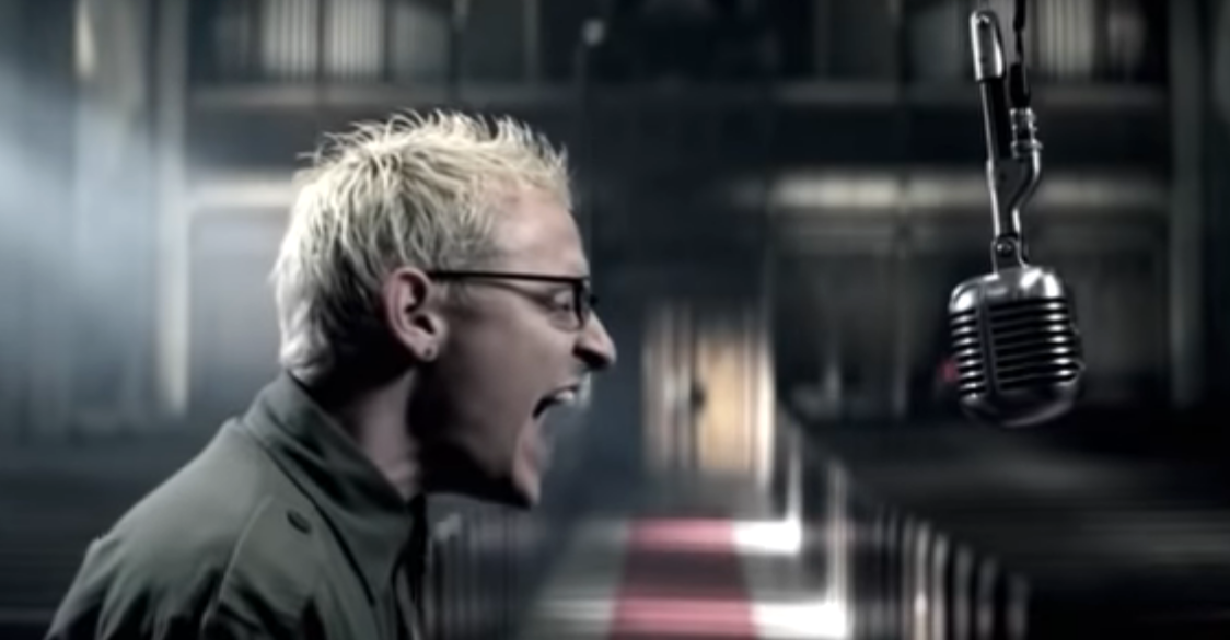 Still from the official video for "Numb",: showing Chester Bennington screaming into an overhead mic.
