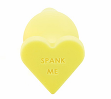 yellow butt plug that says "spank me"