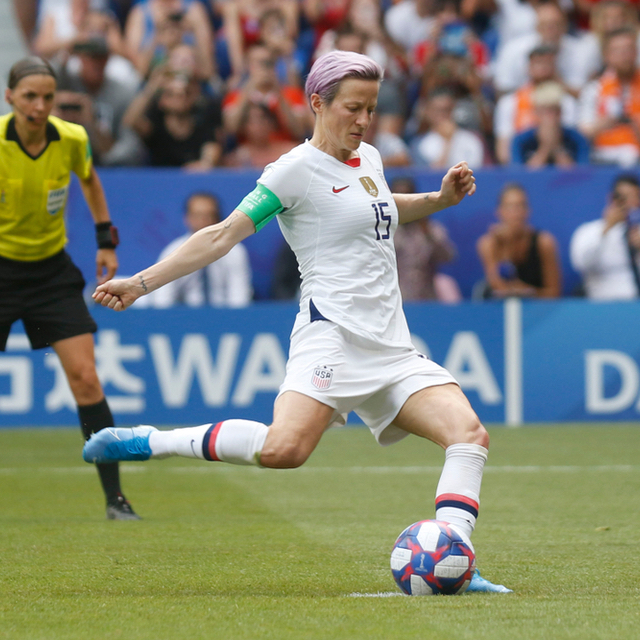 Soccer player Megan Rapinoe kicks a soccer ball