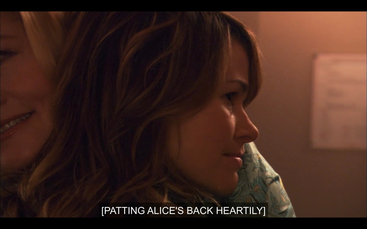 Phyllis and Alice hugging. Alice's head is on Phyllis's shoulder. Subtitles read, "[Patting Alice's back heartily.]"
