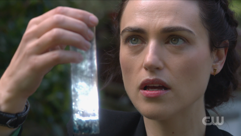 Lena looks at her magic vial 