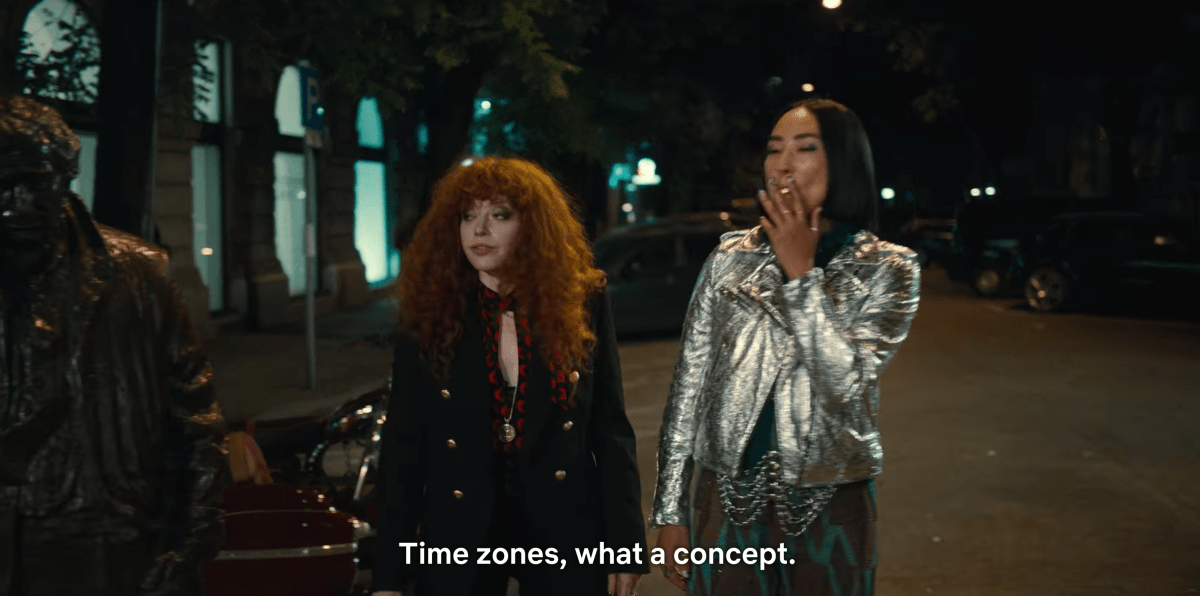 Natasha Lyonne as Nadia and Greta Lee as Maxine walk along a street in Budapest in Russian Doll season two. Nadia says: Time zones, what a concept?