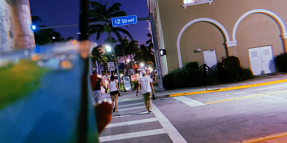 Walking on 12th Street with a drink