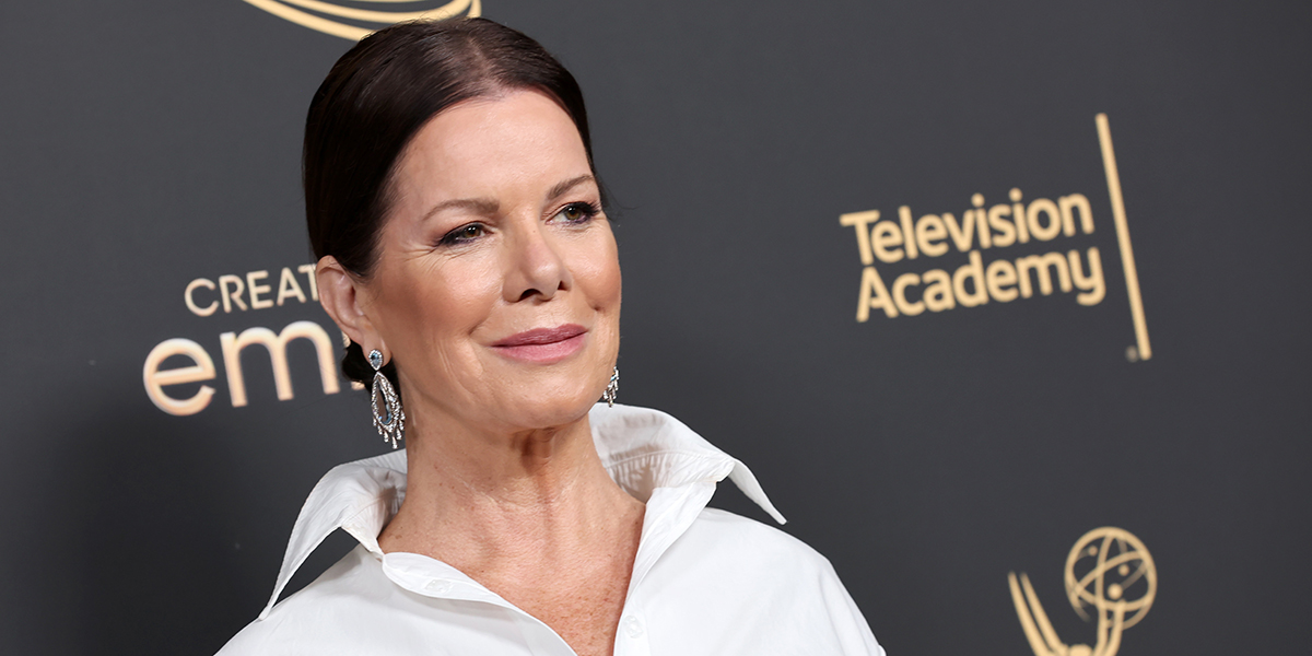 Marcia Gay Harden attends the 2022 Creative Arts Emmys in a white shirt, unbuttoned, with an ENORMOUS collar.