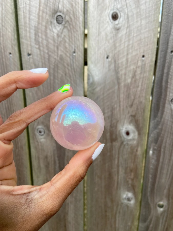 fingers holding a crystal ball