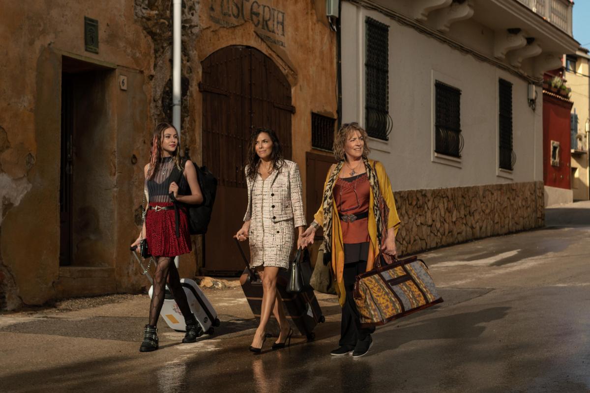 three women in land of women walking through town confused