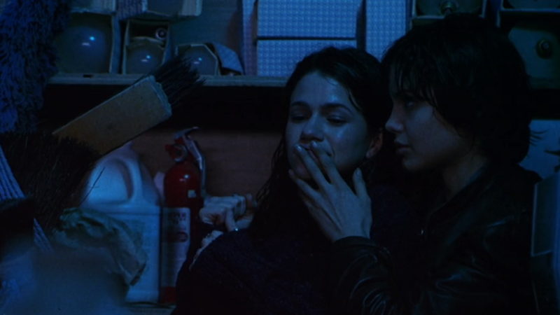 Foxfire: Angelina Jolie as Legs puts her fingers over Maddy's lips while in a storage closet.