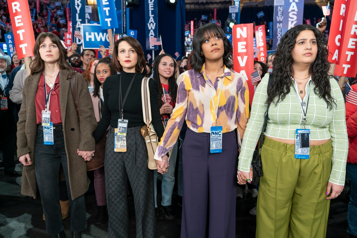 women holding hands at an election event