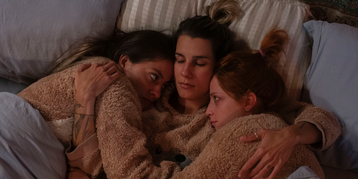 three girls in bed together