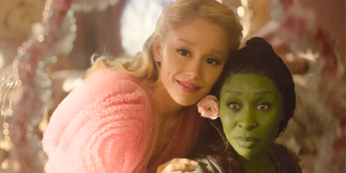 Glinda and Elphaba looking in a mirror together