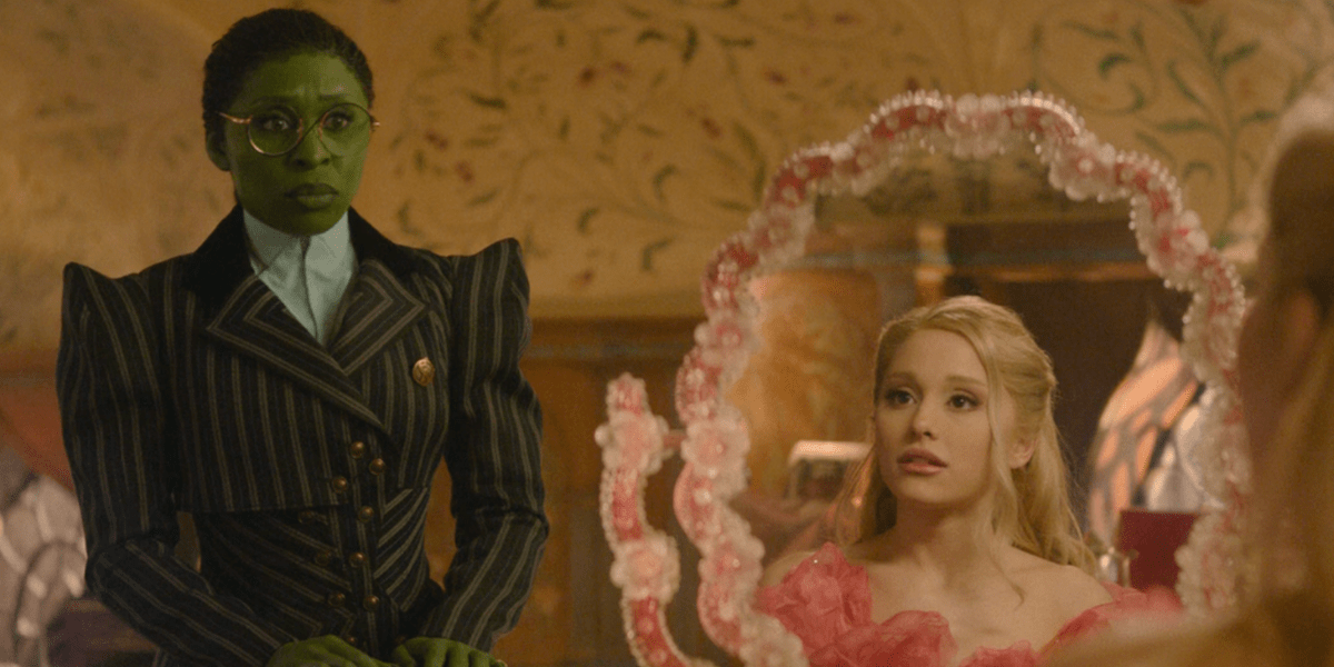 Elphaba looking at Glinda who is looking in a mirror