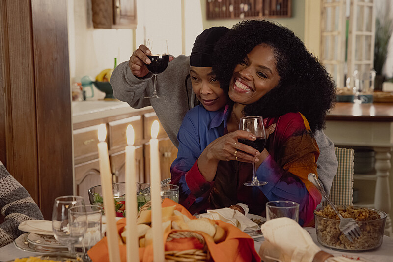 LaPorsha and Nina embrace and raise a glass in celebration of their upcoming trip.