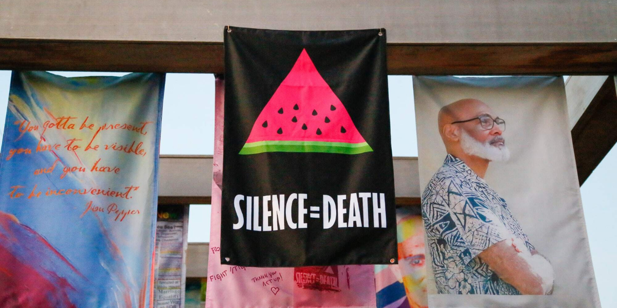 ACT UP NY sign that says SILENCE = DEATH with a watermelon on it