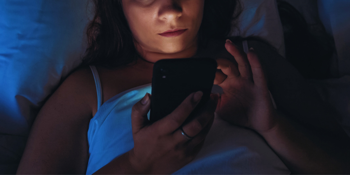 a person on their phone in bed