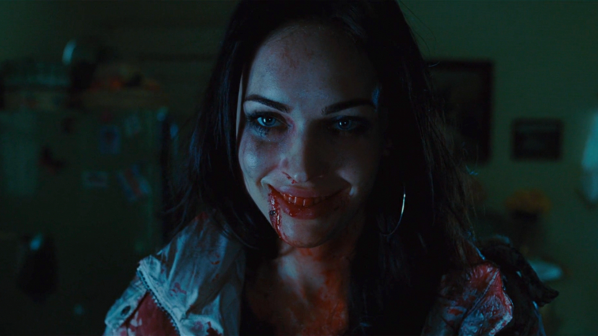 A demonic Megan Fox smiles.