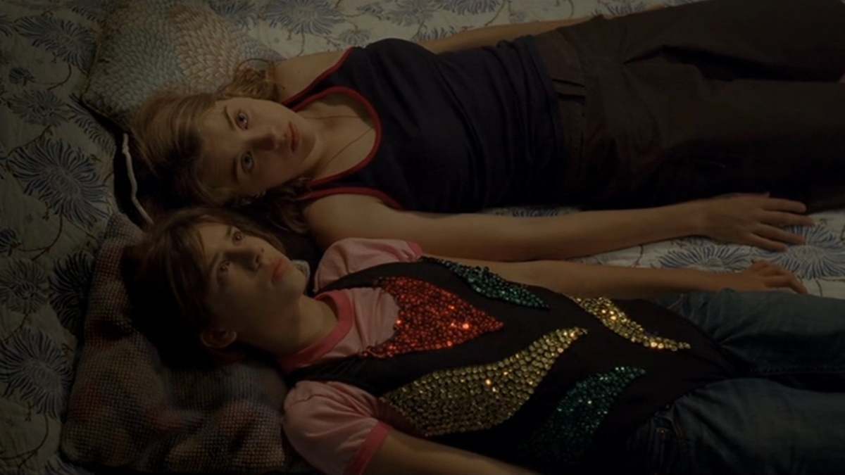 Best lesbian movies #35: Two teen girls lie in bed next to each other.