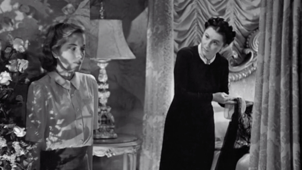 Mrs. Danvers displays Rebecca's clothes to the second Mrs. DeWinter.
