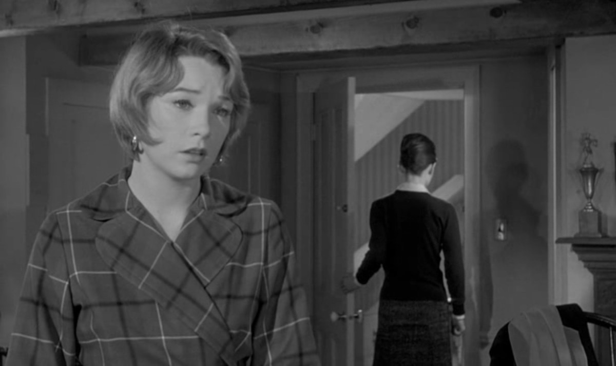 Shirley MacLaine looks forlorn as Audrey Hepburn walks out the door behind her