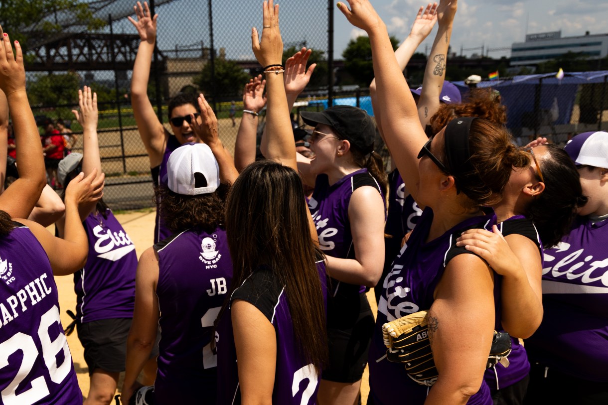 a team celebrates after a softball game