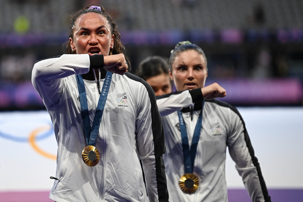 New Zealand's players perform a haka as they celebrate with their gold medals during the victory ceremony following the women's gold medal rugby sevens match between New Zealand and Canada during the Paris 2024 Olympic Games at the Stade de France in Saint-Denis on July 30, 2024. (Photo by CARL DE SOUZA / AFP) (Photo by CARL DE SOUZA/AFP via Getty Images)