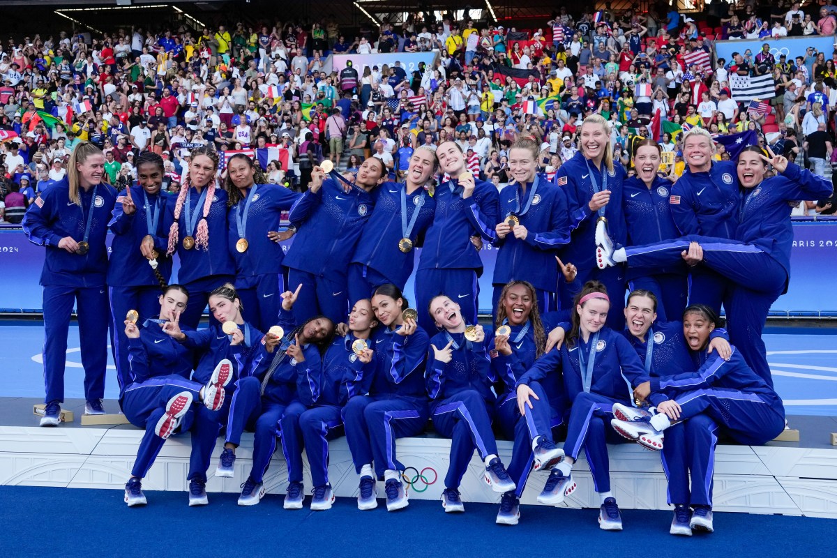 PARIS, FRANCE - AUGUST 10: (L-R) Alyssa Naeher , Naomi Girma , Emily Fox , Trinity Rodman , Korbin Albert , Casey Krueger , Crystal Dunn , Mallory Swanson , Lynn Williams , Sophia Smith , Lindsey Horan , Jenna Nighswonger , Tierna Davidson , Jaedyn Shaw , Emily Sonnett , Casey Murphy , Rose Lavelle , Samantha Coffey , celebrate their victory and pose with their gold medals after the Women's Gold Medal match between Brazil and United States of America during the Olympic Games Paris 2024 at Parc des Princes on August 10, 2024 in Paris, France. (Photo by Daniela Porcelli/ISI Photos/Getty Images)