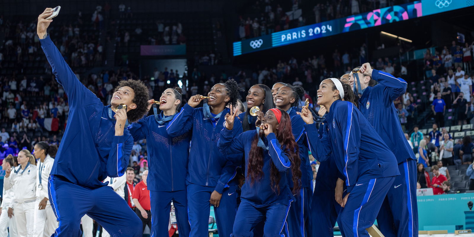 PARIS, FRANCE: AUGUST 11: Brittney Griner takes a selfie of The United States team of Jewell Loyd, Kelsey Plum, Sabrina Ionescu, Kahleah Copper, Chelsea Gray, A'Ja Wilson, Breanna Stewart, Napheesa Collier, Diana Taurasi, Jackie Young, and Alyssa Thomas as they celebrate with their gold medals after the Women's Basketball Medal Games at the Bercy Arena during the Paris 2024 Summer Olympic Games on August 11th, 2024 in Paris, France. (Photo by Tim Clayton/Corbis via Getty Images)