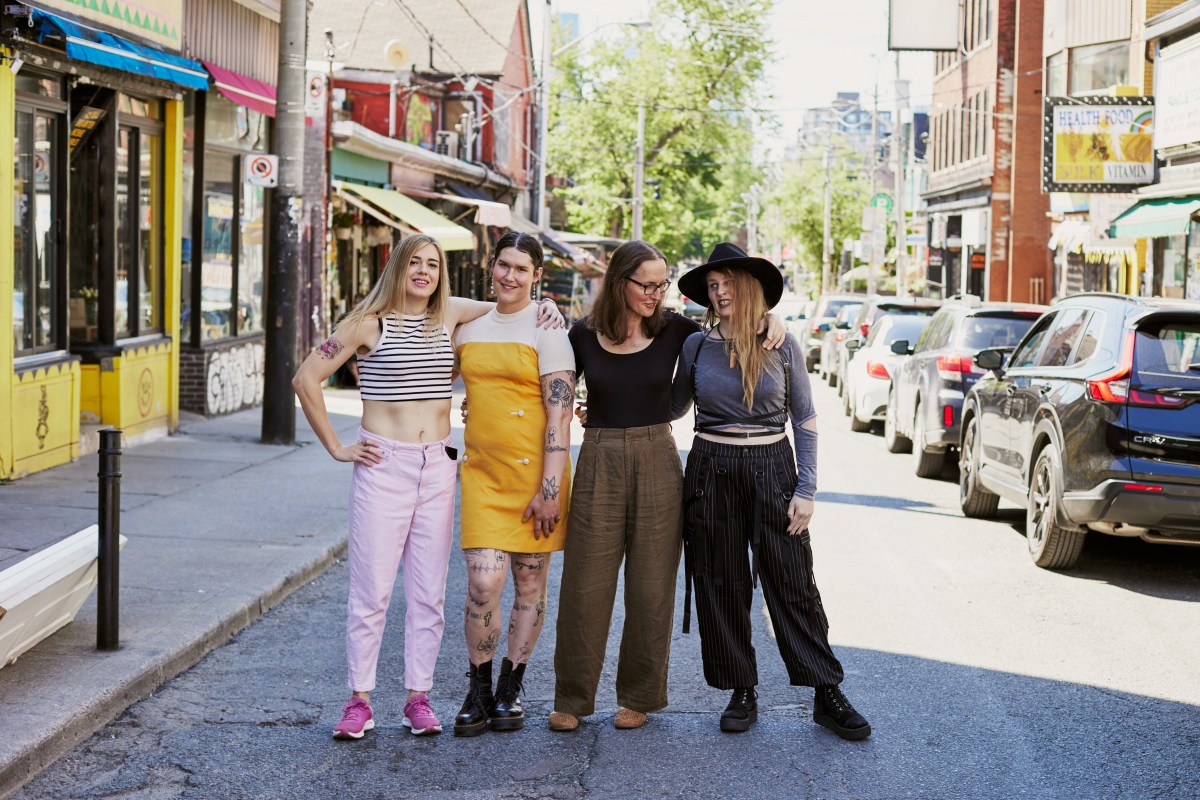 Djuna and her team pose in streetwear outside their office.