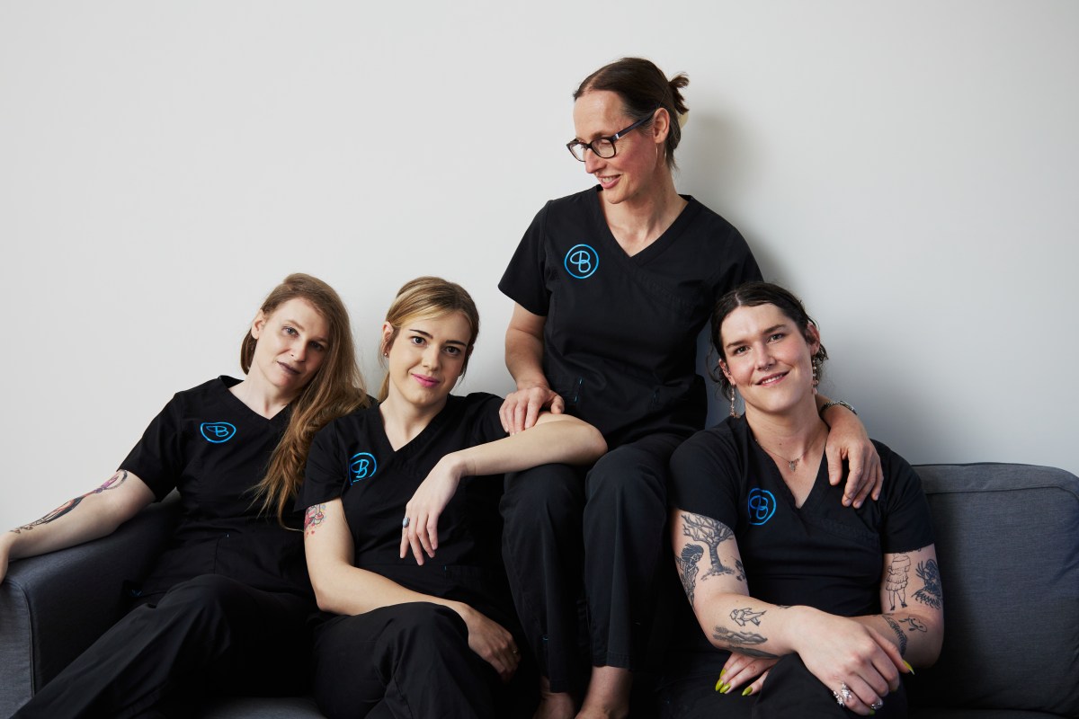 Djuna and her Bluebird Laser team pose on a couch