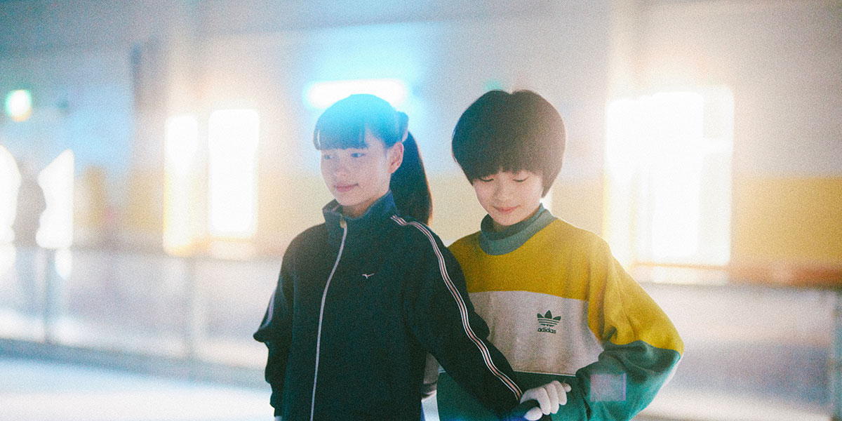 Kiara Nakanishi and Keitatsu Koshiyama skate together in My Sunshine, a soft glow of light behind them.