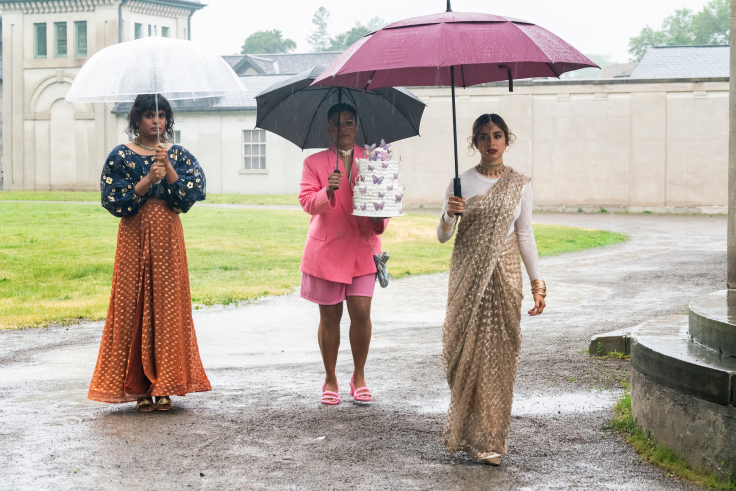 three women outside with umbrealls in the rain