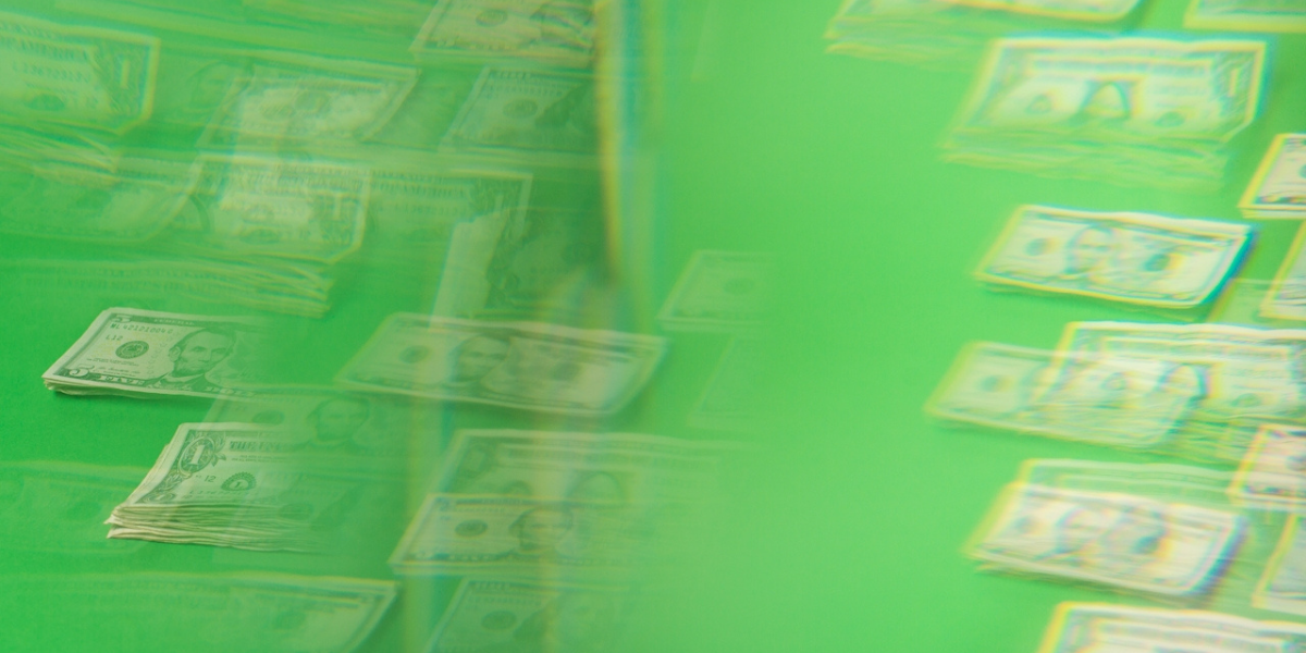 Trans financial planners: washed out bright green image with visible dollar bills in the background.