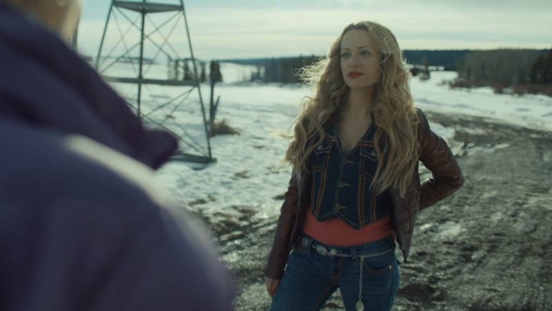 wynonna earp vengeance: mina standing with her hand on her hip in a VERY 2000s outfit