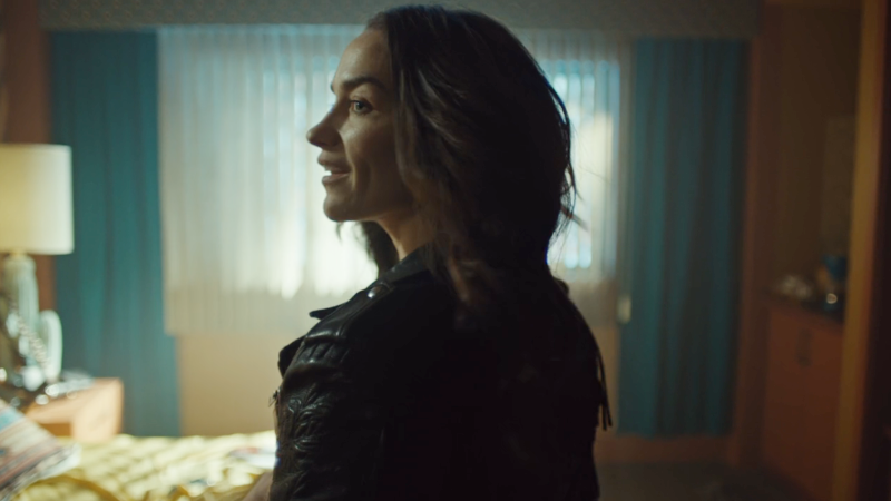 wynonna earp vengeance: wynonna looks over the shoulder of her iconic leather jacket