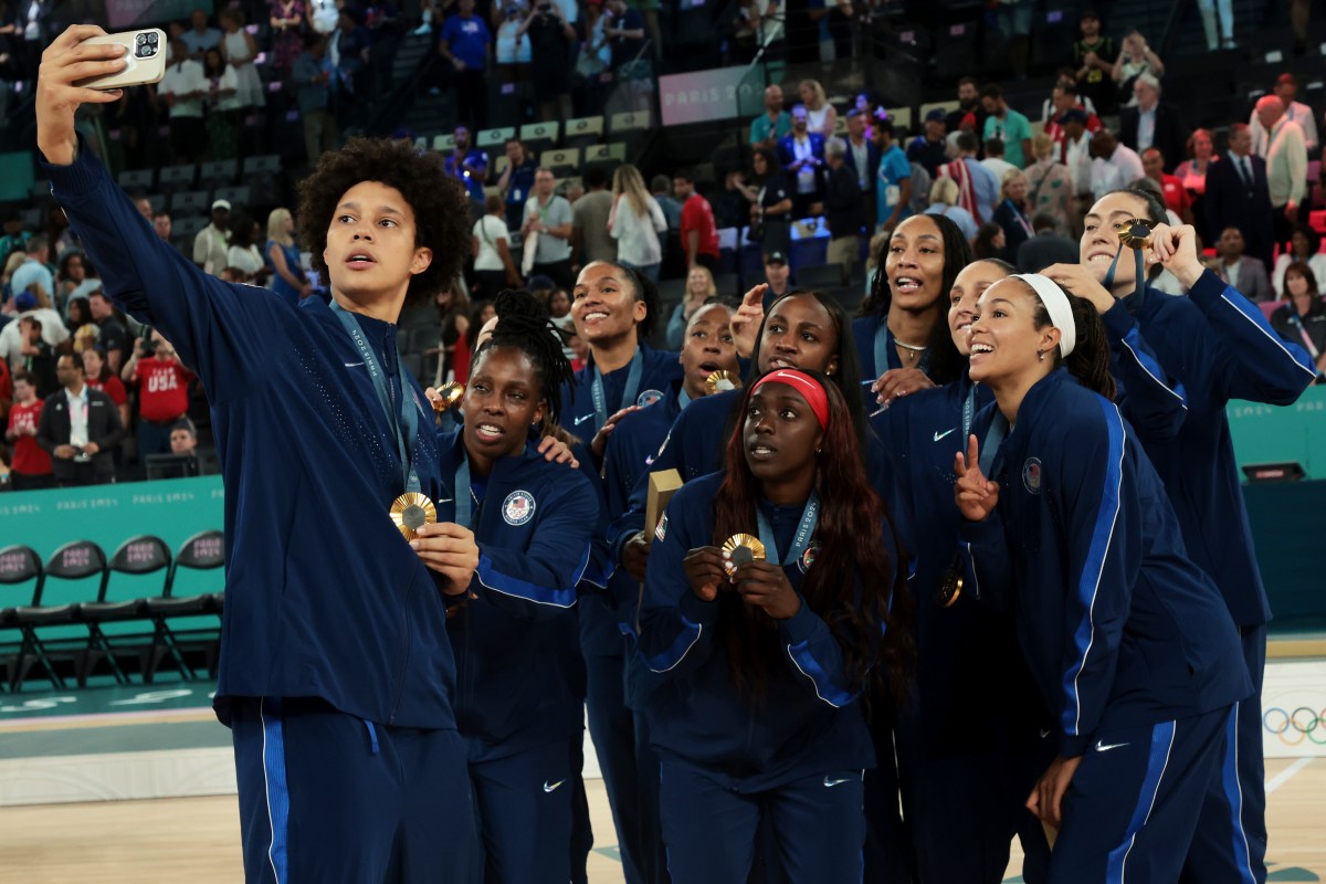 PARIS, FRANCE - AUGUST 11: Gold medalist Brittney Griner of Team United States takes a selfie during the Women's basketball medal ceremony on day sixteen of the Olympic Games Paris 2024 at Bercy Arena on August 11, 2024 in Paris, France. (Photo by Jean Catuffe/Getty Images)