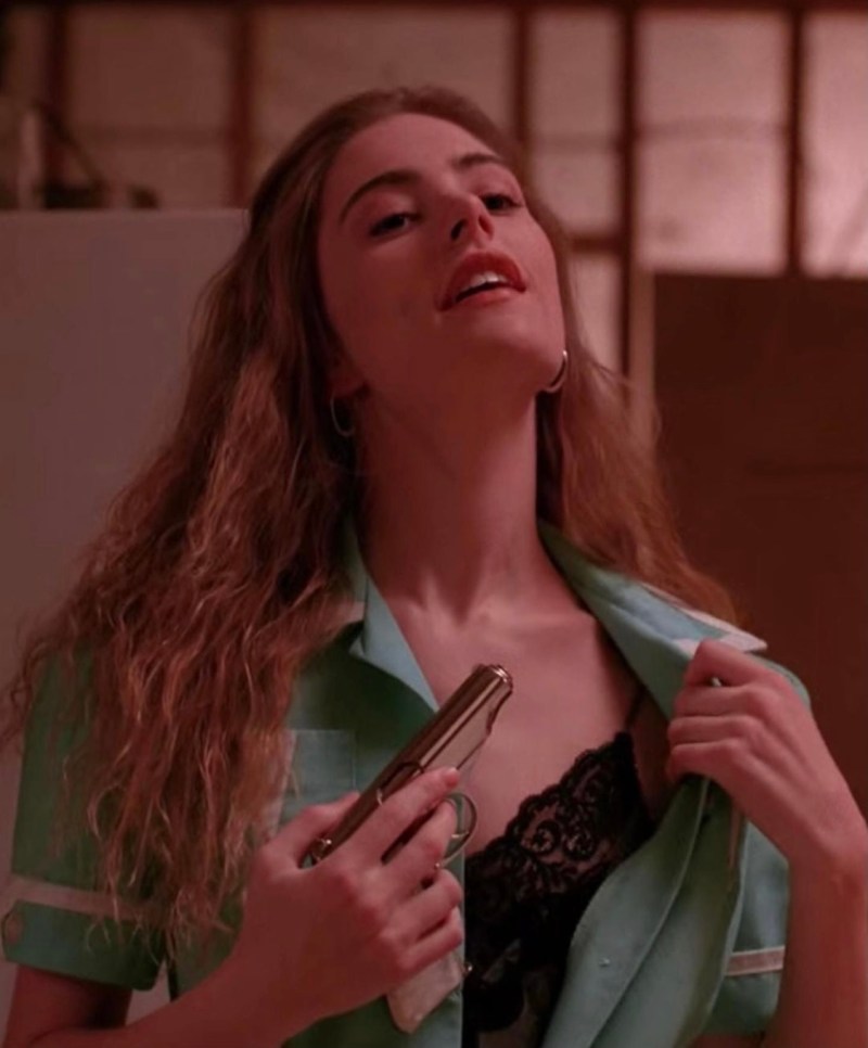 Shelly in Twin Peaks rests a gun on her open dress