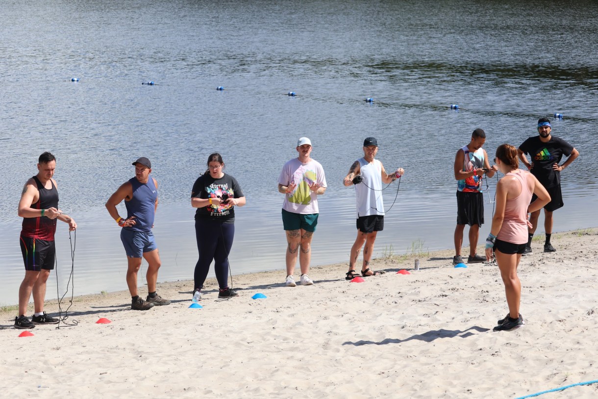 a group of queer people on a lake