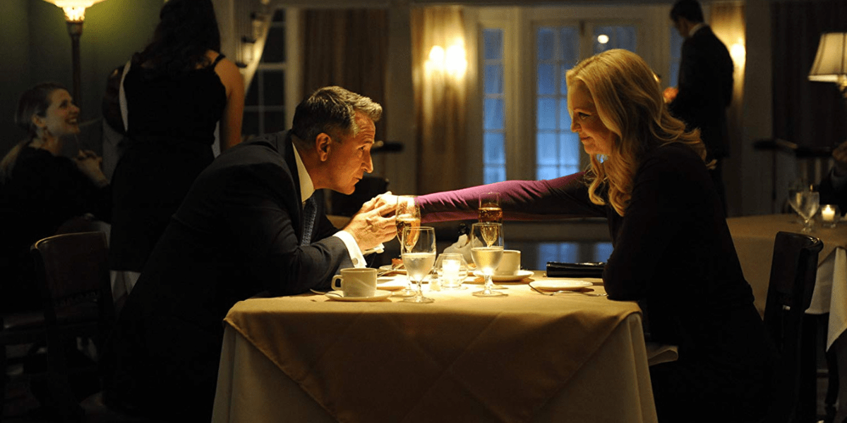 Joan Allen as Darcy Anderson and Anthony LaPaglia as Bob Anderson in A Good Marriage sit at a dinner table