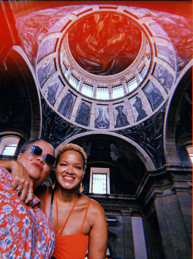 lesbian couple smiling in a big museum