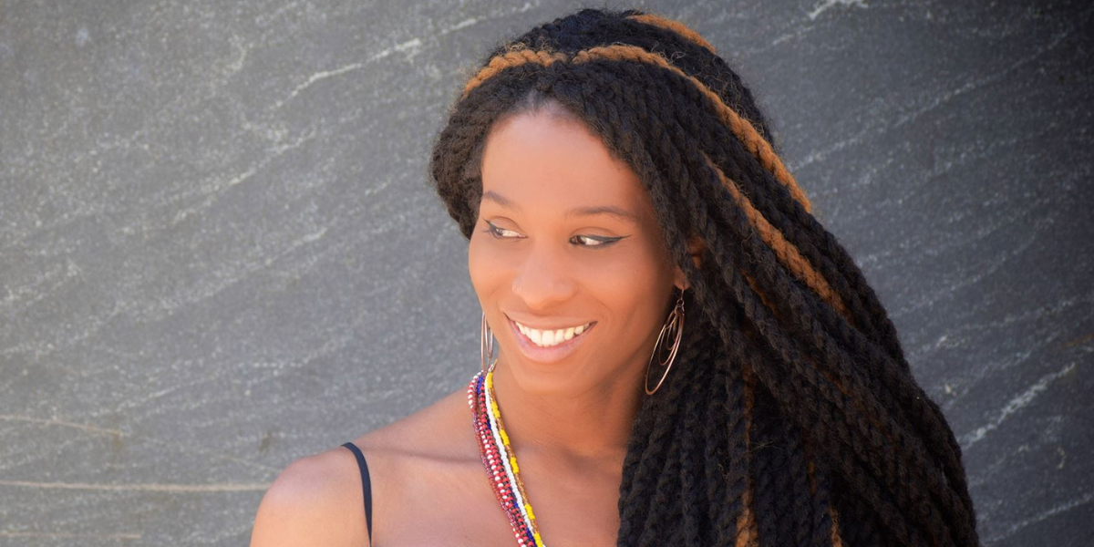 A close up head shot of Lady Dane Figueroa Edidi as she looks off to the side.