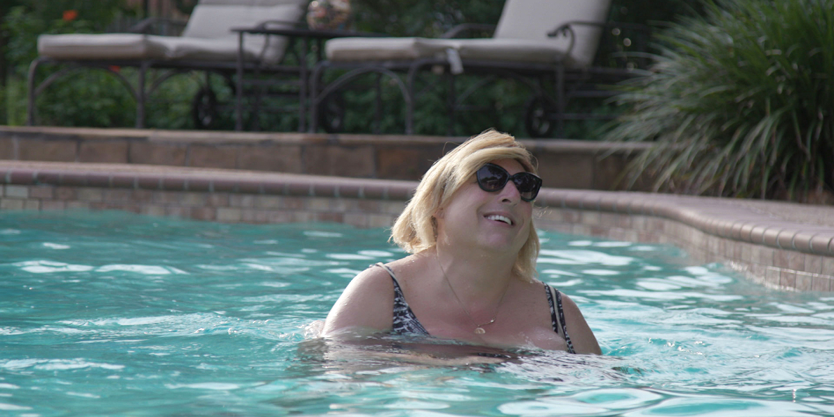 Our Dad Danielle documentary interview: Danielle smiles wearing sunglasses in a pool