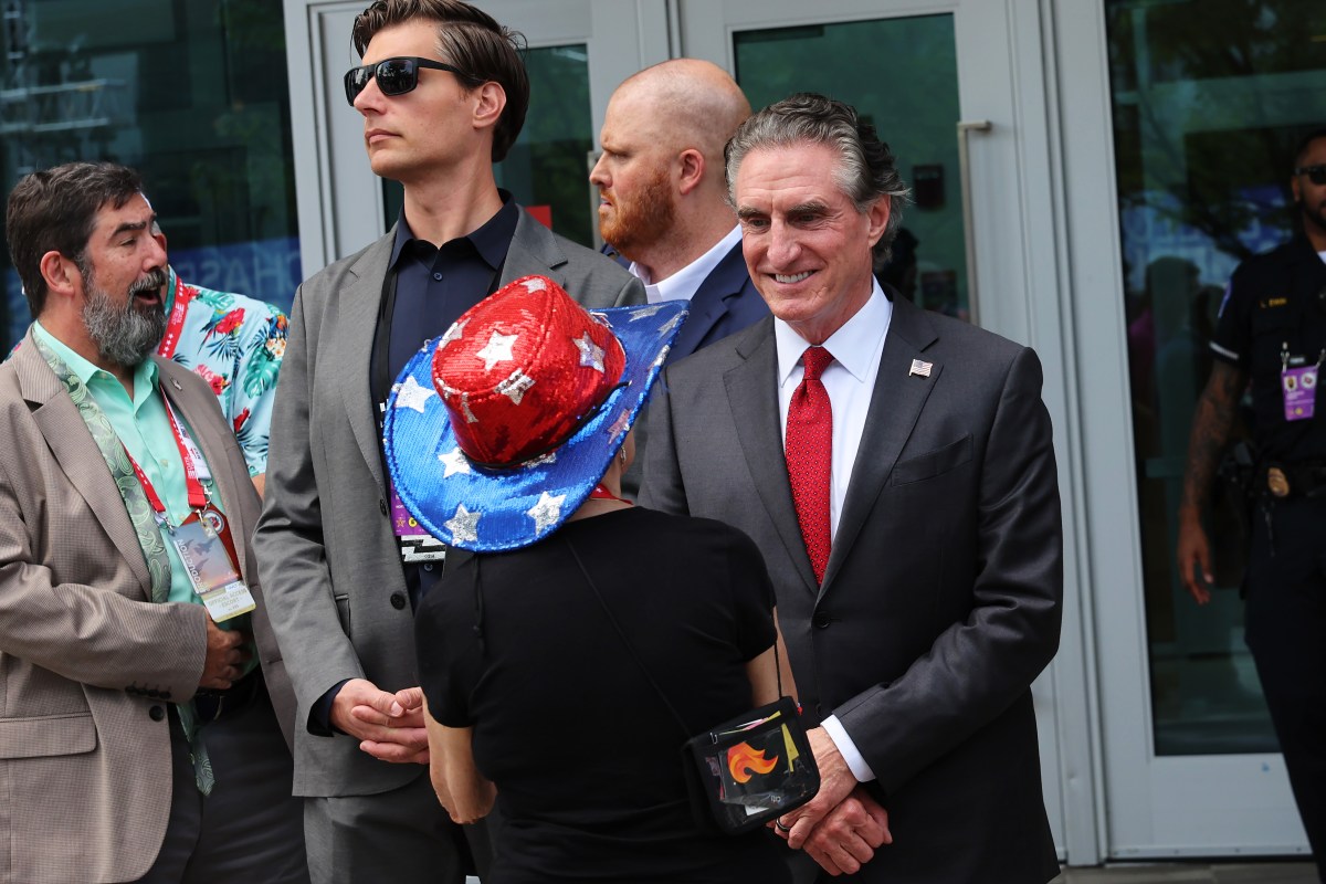 MILWAUKEE, WISCONSIN - JULY 16: North Dakota Gov. Doug Burgum speaks with an attendee of the 2024 Republican National Convention at the Fiserv Forum on July 16, 2024 in Milwaukee, Wisconsin. The RNC continues on it's second day following the formal nomination of Republican presidential candidate former President Donald Trump for the GOP nomination in the 2024 U.S. Presidential election and Sen. J.D. Vance (R-OH) to be his Vice President. (Photo by Michael M. Santiago/Getty Images)