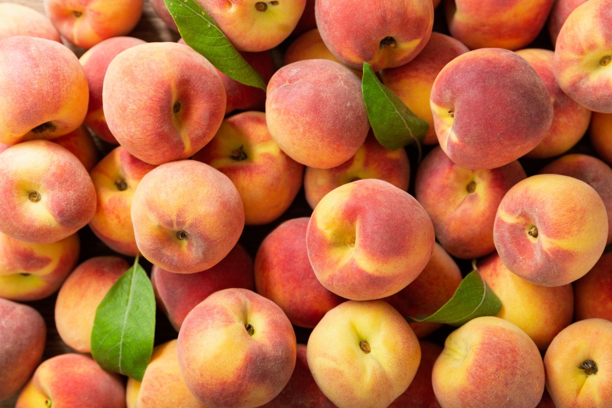 fresh ripe peaches as background, top view