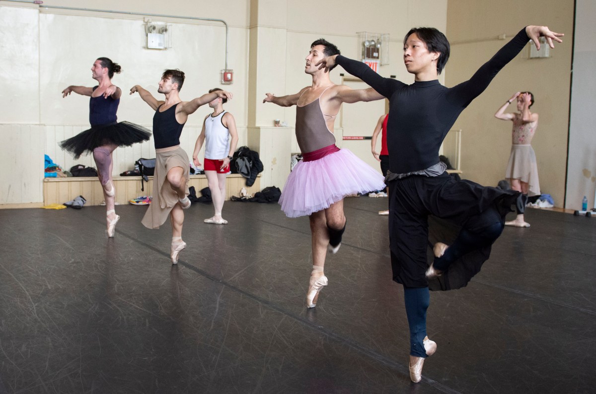 A group of dancers from the Trocks dance in rehearsal.