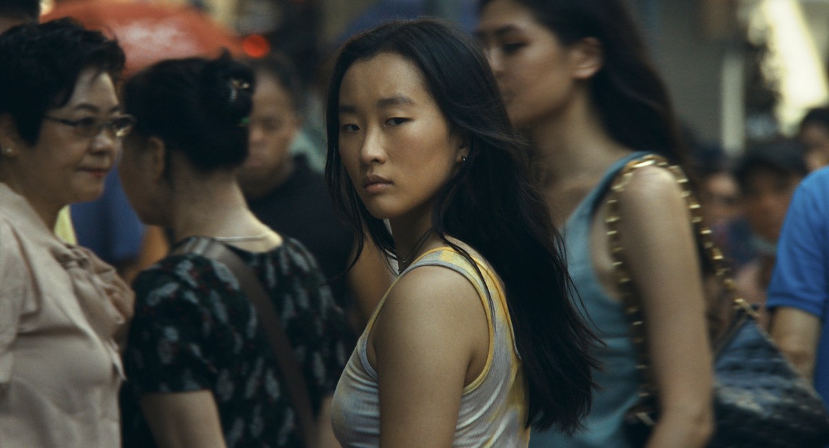 Ji-young Yoo turns to face the camera amid a crowd.