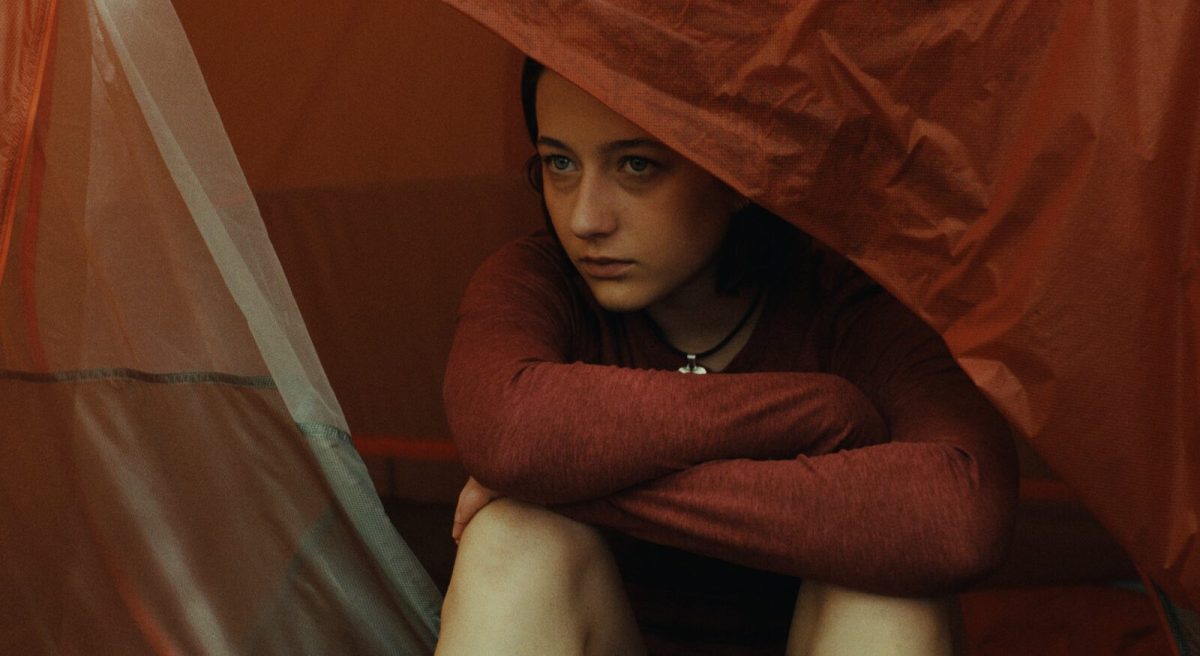 The best queer movies of 2024: Lily Colias sits in a tent in Good One