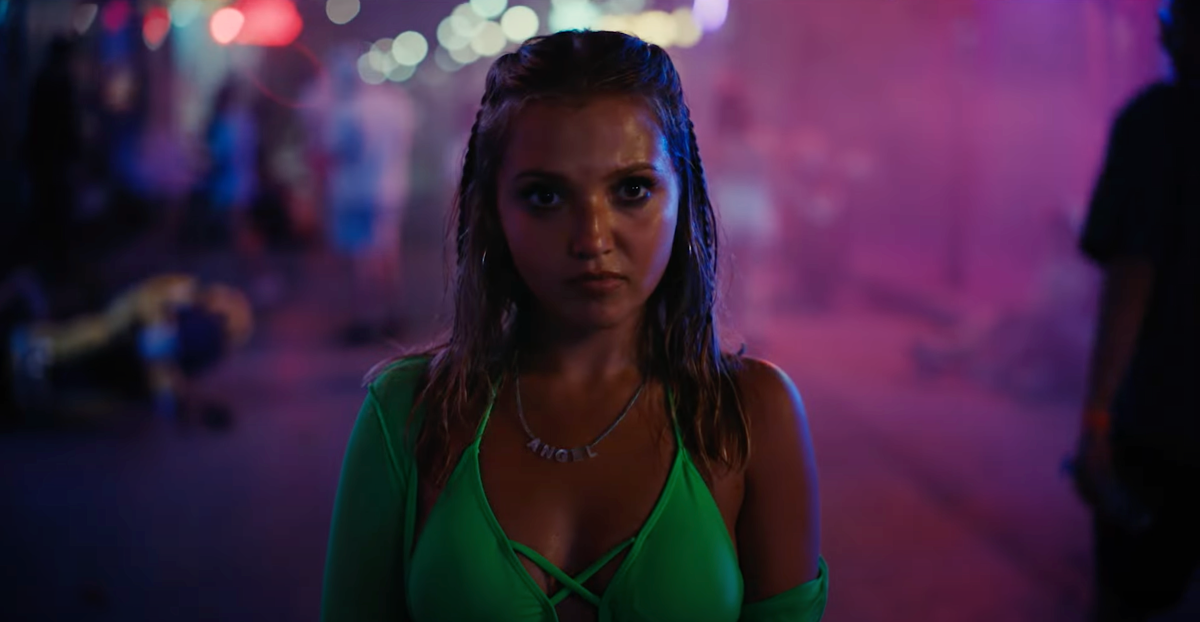 Mia McKenna-Bruce in How to Have Sex in a green bikini top at night.