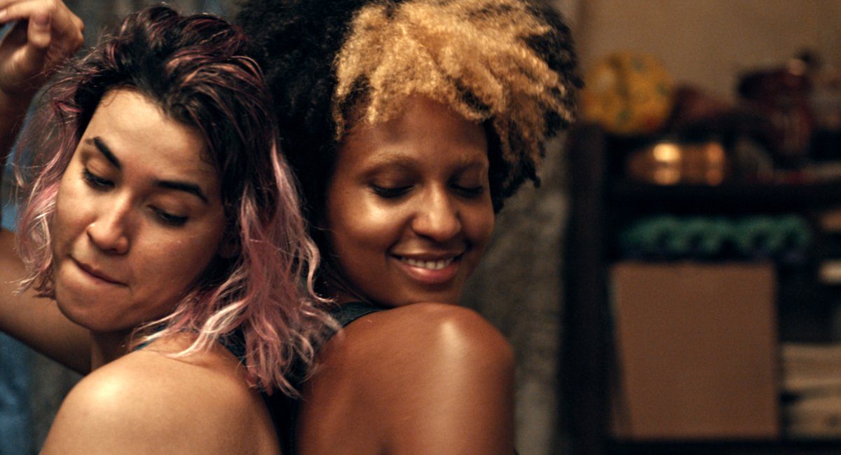 The best queer movies of 2024: two queer teenagers dance back to back with smiles on their faces.