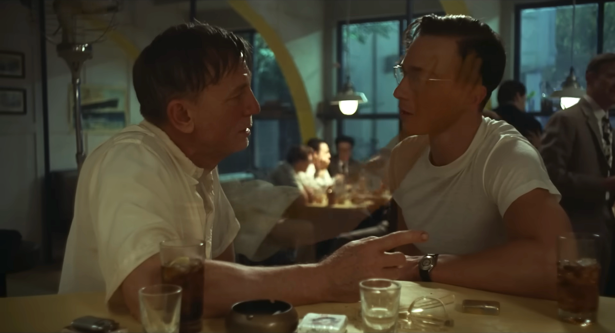 Daniel Craig talks to Drew Starkey at a bar, a phantom hand floating up to touch his face.